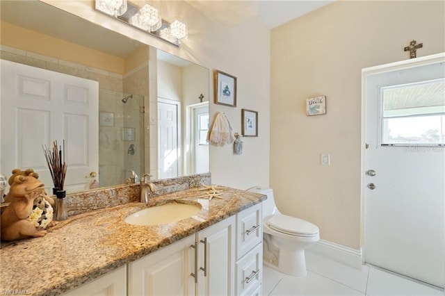 bathroom featuring toilet, a shower with door, tile patterned floors, and vanity