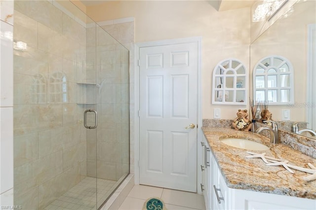 bathroom featuring walk in shower, vanity, and tile patterned floors