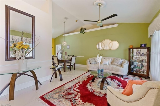 living room with lofted ceiling, ceiling fan, and light tile patterned floors