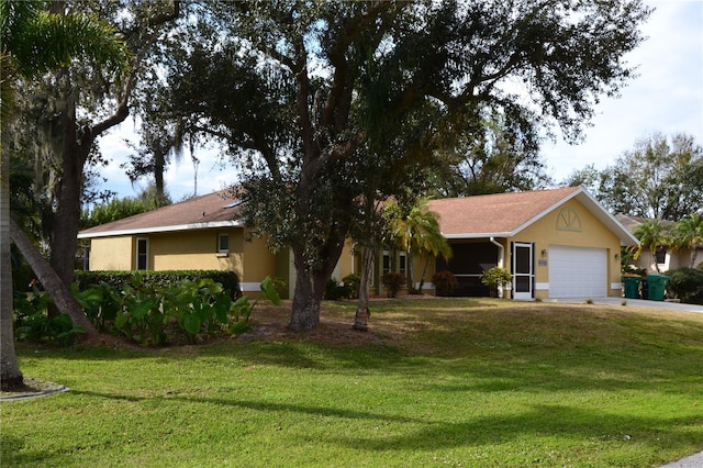 ranch-style house featuring a garage and a front lawn