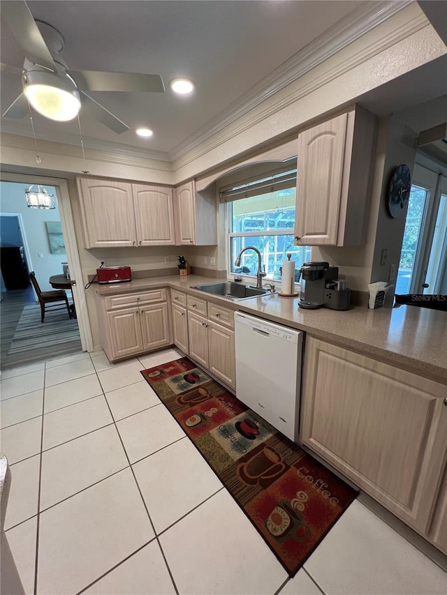 kitchen with light tile patterned flooring, light brown cabinetry, sink, crown molding, and dishwasher