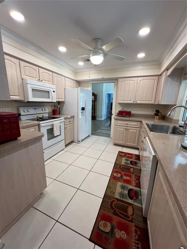 kitchen featuring crown molding, sink, white appliances, and light tile patterned floors