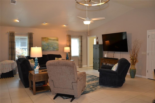 living room with lofted ceiling, light tile patterned floors, and ceiling fan