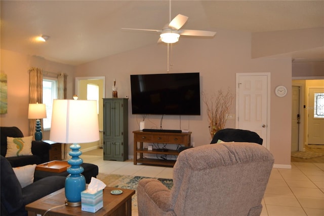 living room with ceiling fan, lofted ceiling, and light tile patterned floors