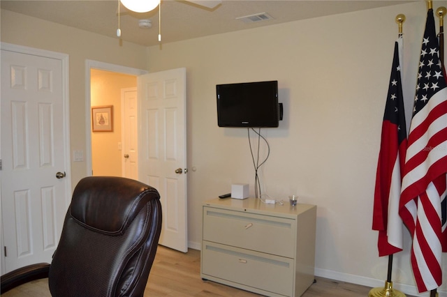 office with light hardwood / wood-style flooring