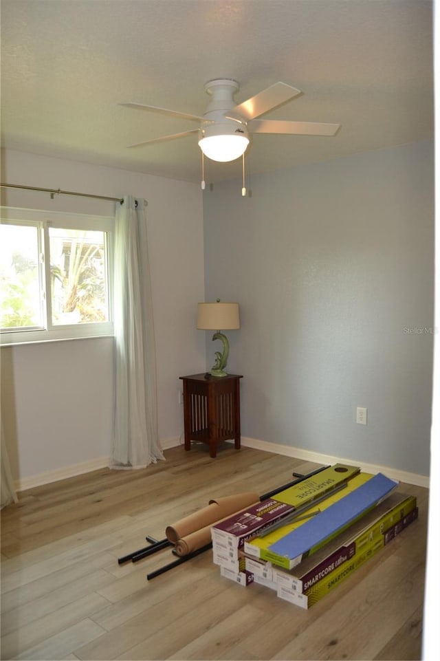 bedroom with ceiling fan and light hardwood / wood-style floors