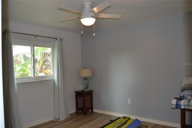 unfurnished bedroom with ceiling fan and light wood-type flooring