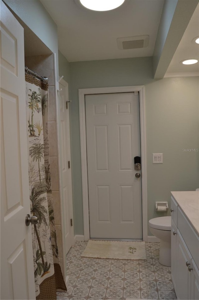 bathroom featuring a shower with curtain, vanity, toilet, and tile patterned flooring