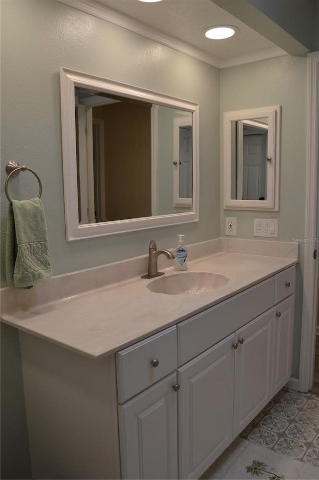 bathroom with tile patterned flooring, vanity, and ornamental molding