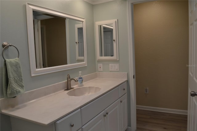 bathroom with vanity and hardwood / wood-style floors