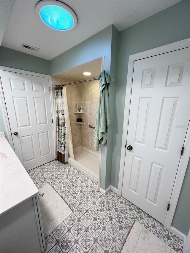 bathroom with vanity, a shower with curtain, and tile patterned floors