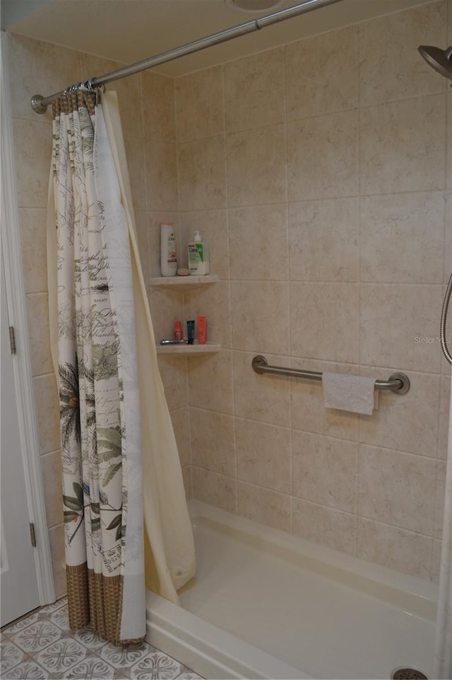 bathroom with tile patterned flooring and curtained shower