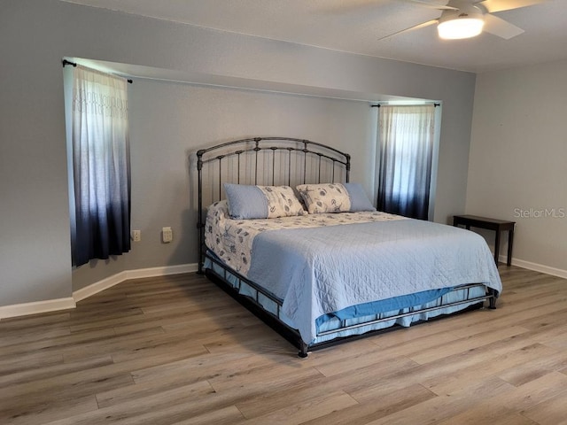 bedroom with hardwood / wood-style flooring and ceiling fan