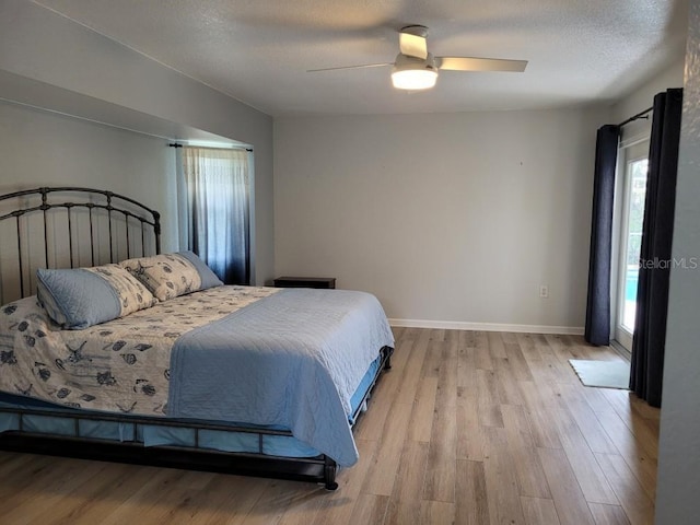 bedroom featuring a textured ceiling, light hardwood / wood-style flooring, and ceiling fan