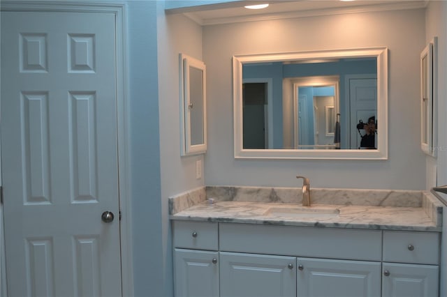 bathroom featuring ornamental molding and vanity