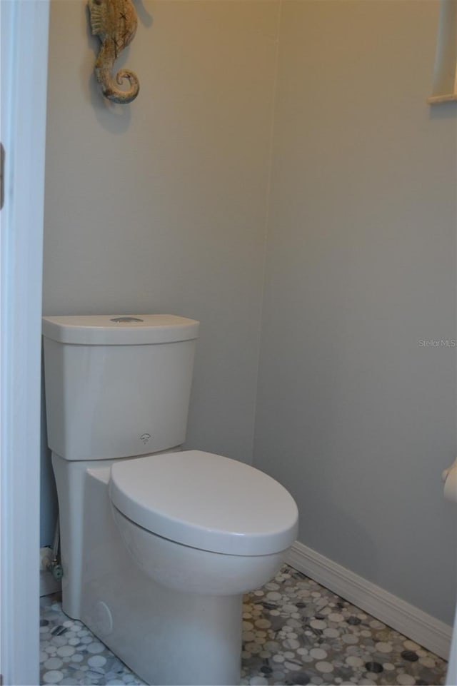 bathroom featuring toilet and tile patterned flooring