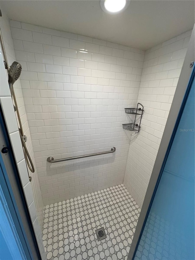 bathroom with a tile shower