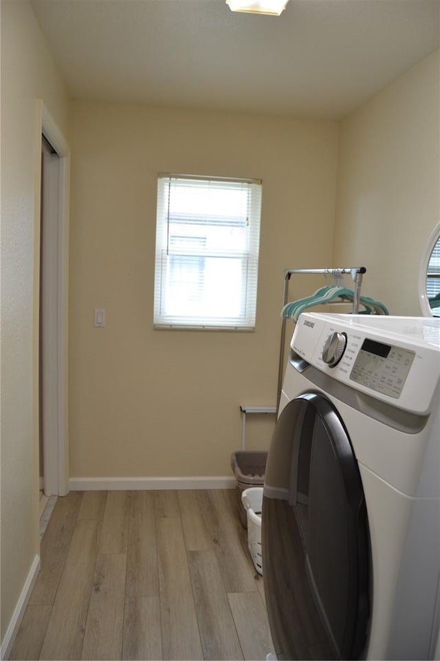 washroom featuring washer / dryer and light hardwood / wood-style flooring