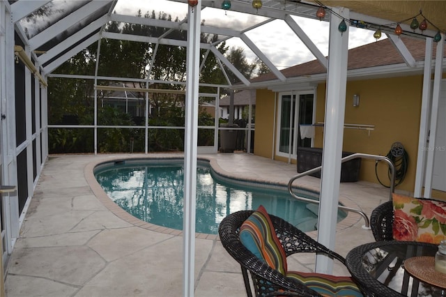 view of swimming pool featuring a lanai and a patio