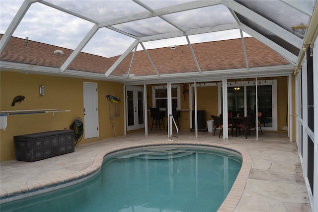 view of pool featuring a lanai, a patio area, and french doors