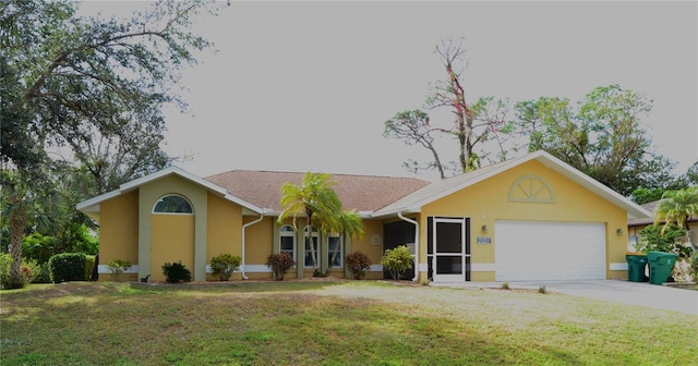 ranch-style home featuring a garage and a front lawn