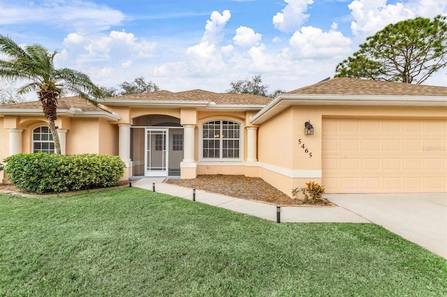 view of front of property featuring a garage and a front yard