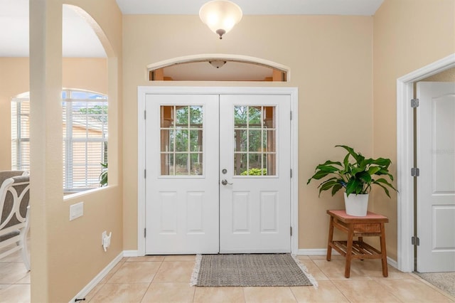 doorway to outside with light tile patterned floors and plenty of natural light