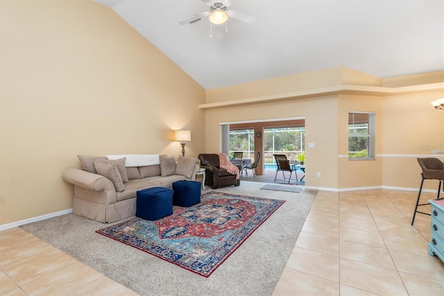 living room featuring ceiling fan, light tile patterned floors, and lofted ceiling