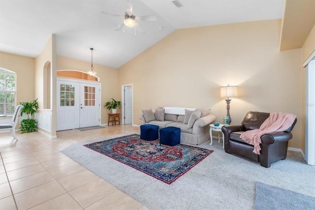 tiled living room featuring ceiling fan, lofted ceiling, and french doors