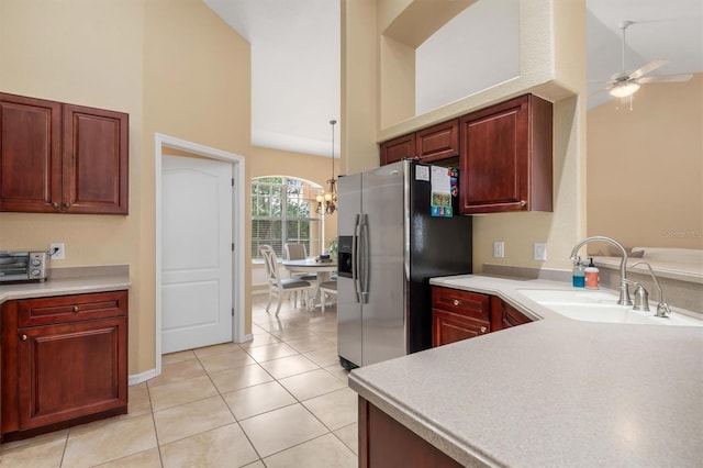 kitchen with stainless steel fridge, ceiling fan, light tile patterned flooring, high vaulted ceiling, and sink