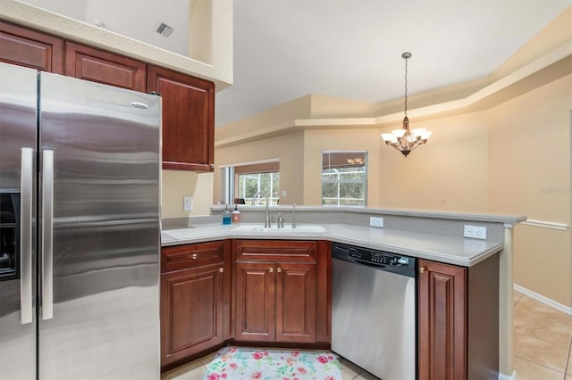 kitchen with sink, an inviting chandelier, light tile patterned flooring, hanging light fixtures, and appliances with stainless steel finishes