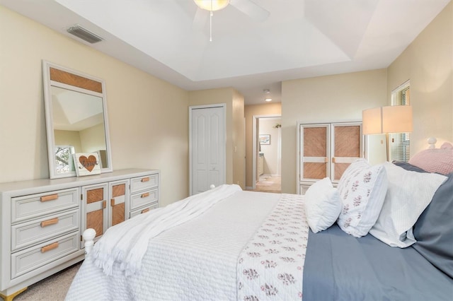 bedroom featuring ceiling fan and a tray ceiling