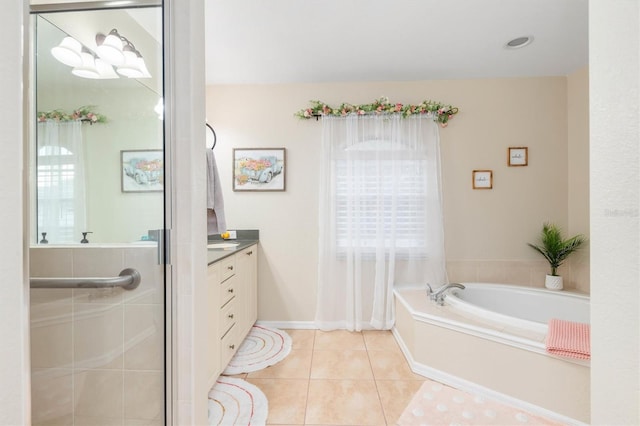 bathroom featuring a bath, tile patterned floors, and vanity