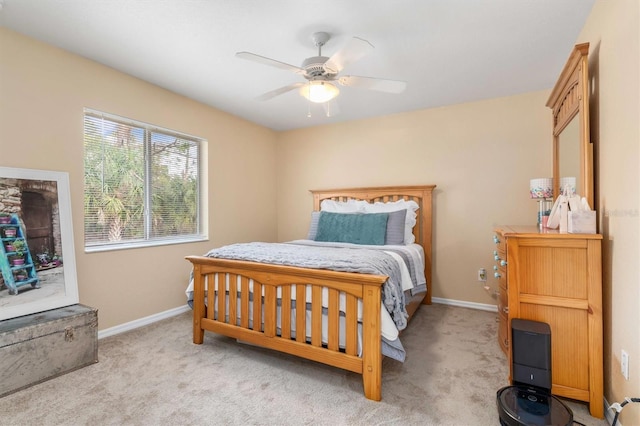 bedroom with ceiling fan and light colored carpet