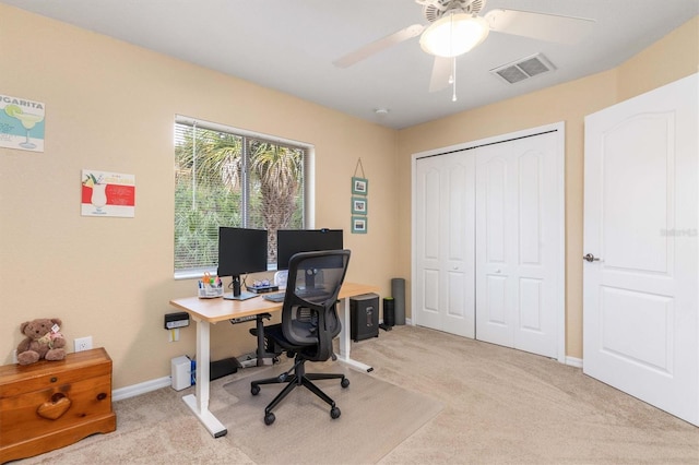 carpeted office with ceiling fan