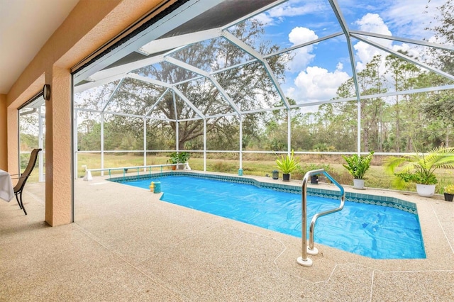 view of swimming pool featuring a patio area and a lanai