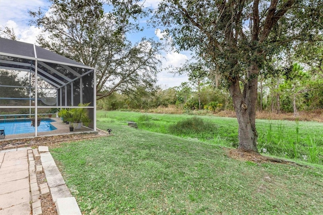 view of yard featuring glass enclosure