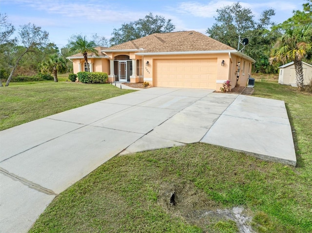 ranch-style home featuring a front lawn, cooling unit, and a garage