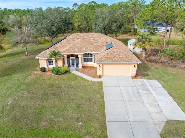 view of front of property with a garage and a front yard