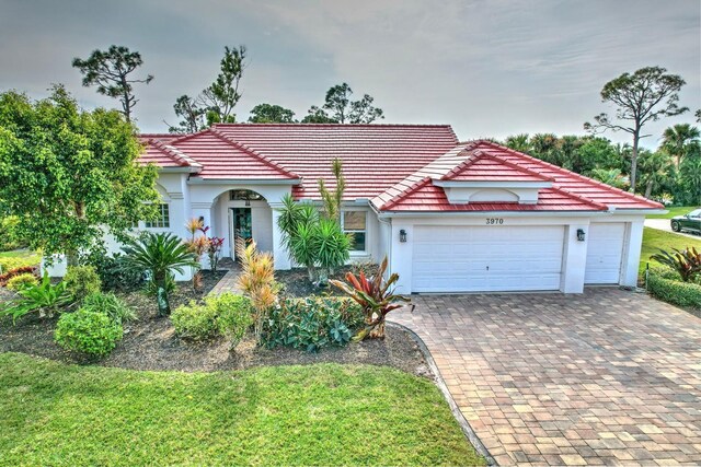 mediterranean / spanish-style house with a garage