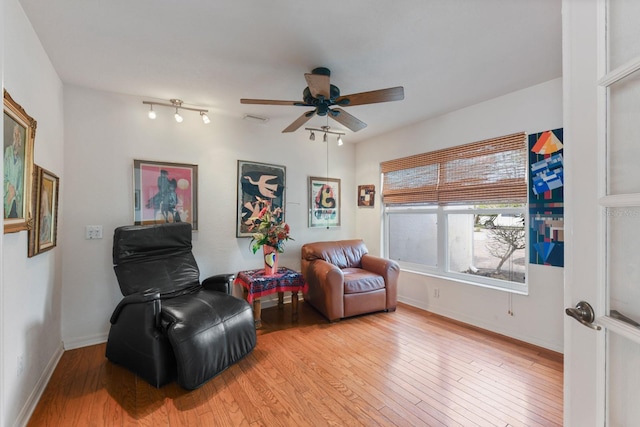 living area featuring ceiling fan and light hardwood / wood-style floors