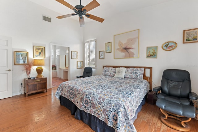 bedroom featuring ceiling fan, hardwood / wood-style flooring, and ensuite bath