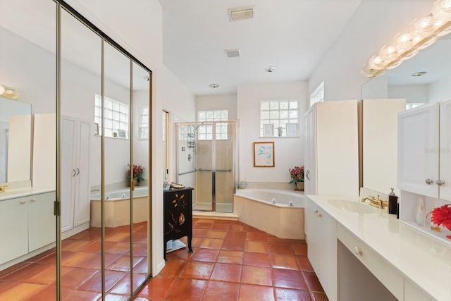 bathroom with vanity, tile patterned floors, and shower with separate bathtub