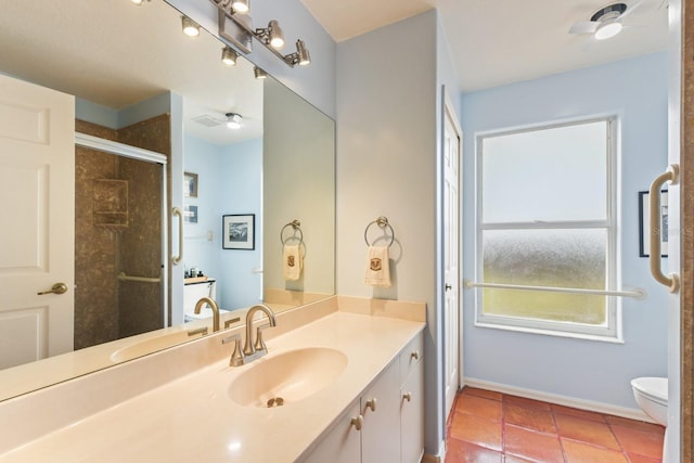 bathroom featuring toilet, ceiling fan, tile patterned floors, and vanity