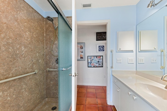 bathroom with tile patterned floors, a shower with door, and vanity