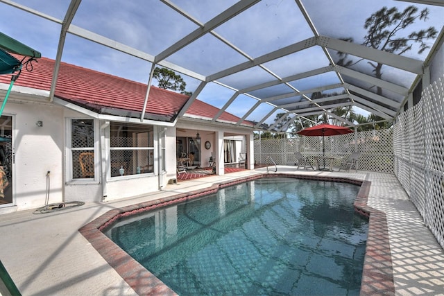 view of swimming pool with a lanai and a patio