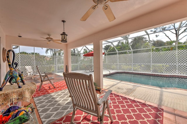 exterior space featuring ceiling fan, a fenced in pool, and glass enclosure