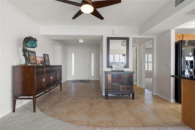 tiled entryway featuring ceiling fan