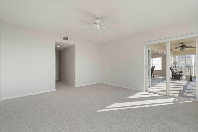 carpeted empty room featuring ceiling fan