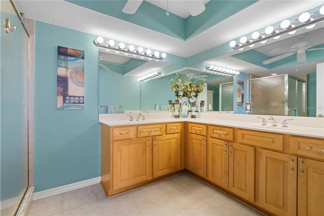 bathroom featuring ceiling fan, a shower with shower door, and vanity